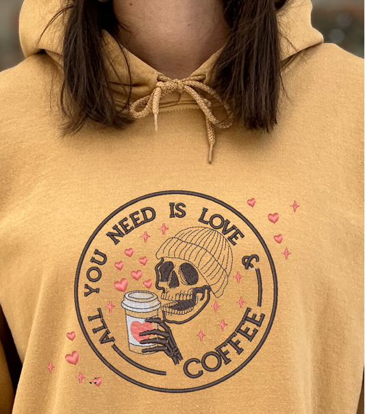 Tan hoodie with skull drinking coffee
